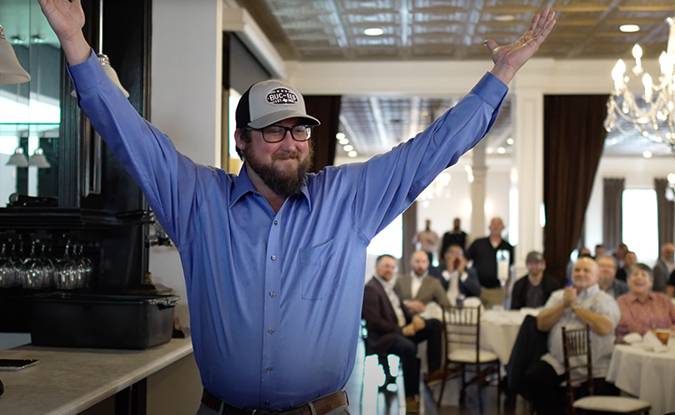 Northern Texas Kickoff Highlight Image of Employee Walking to Stage